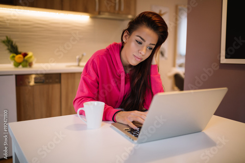 Young woman using laptop computer at home. © Nebojsa