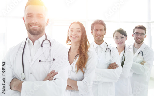 Group of happy successful doctors standing in a row in the hospi