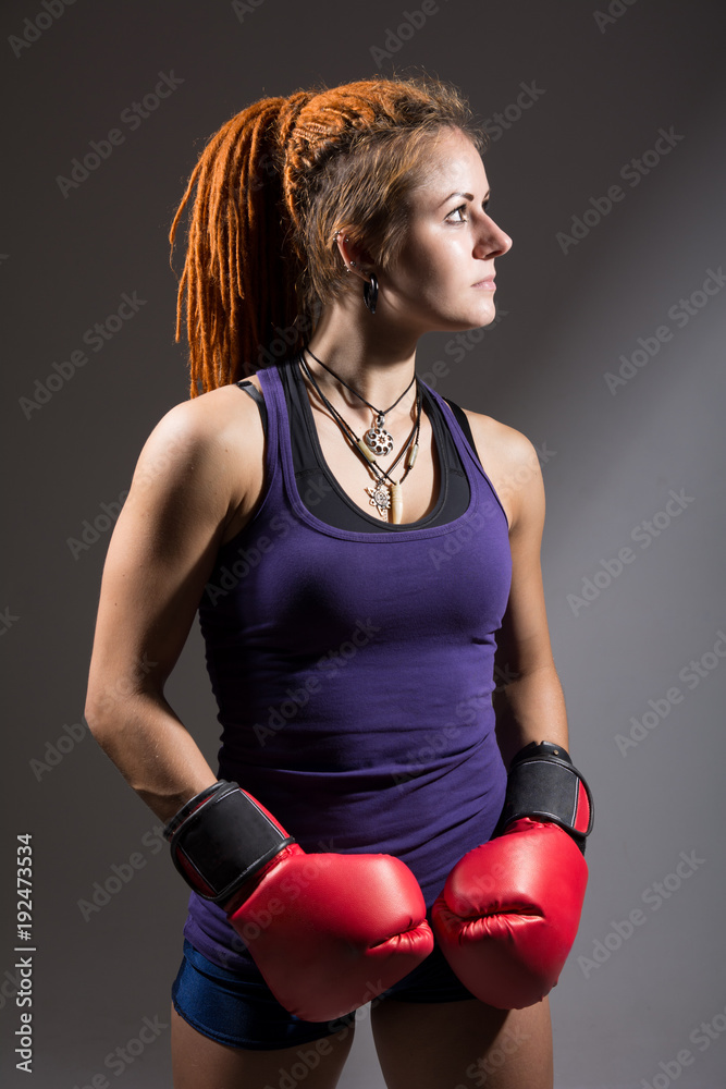 Young woman boxer with dreadlocks