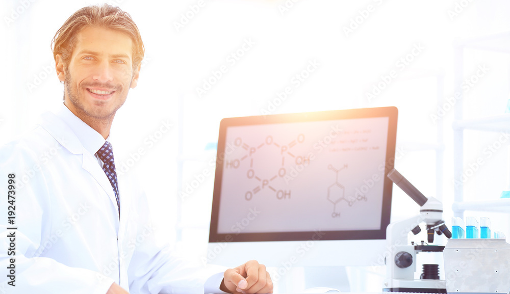 Portrait of a male scientist with a monitor looking at the camer Portrait of a male scientist with a monitor looking at the camer