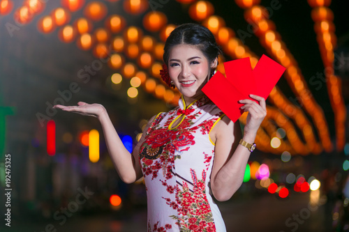 Portrait beautiful Asian woman in Cheongsam dress(Red Chinese dress), Happy Chinese new year concept with night light.