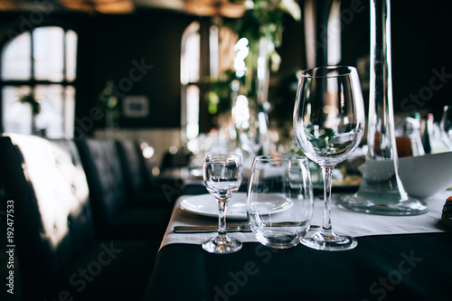 Beautiful dark Wedding table setting with fresh flowers decoration and black table in the restaurant