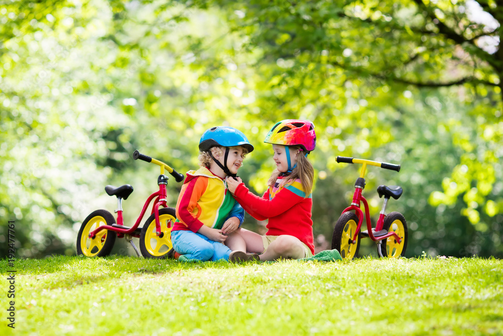 Kids ride balance bike in park Kids ride balance bike in park