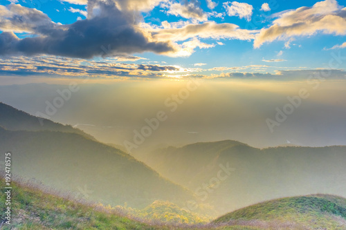 Mountains and tree with beautiful blue sky and cloud  in the morning sunrise. © narongchaihlaw