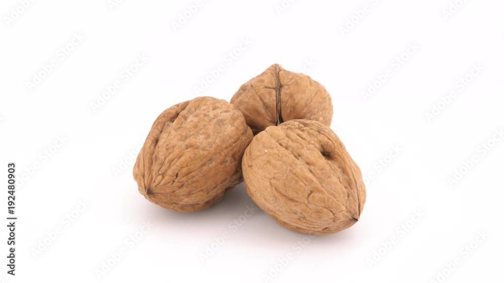 Three walnuts isolated rotating on white background (loopable)