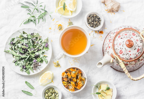 Flat lay liver detox antioxidant tea, teapot and the ingredients for it on a light background, top view. Herbal homeopathic recept concept