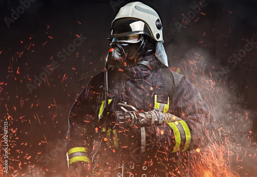 Obraz na plátně A firefighter dressed in a uniform in a studio.