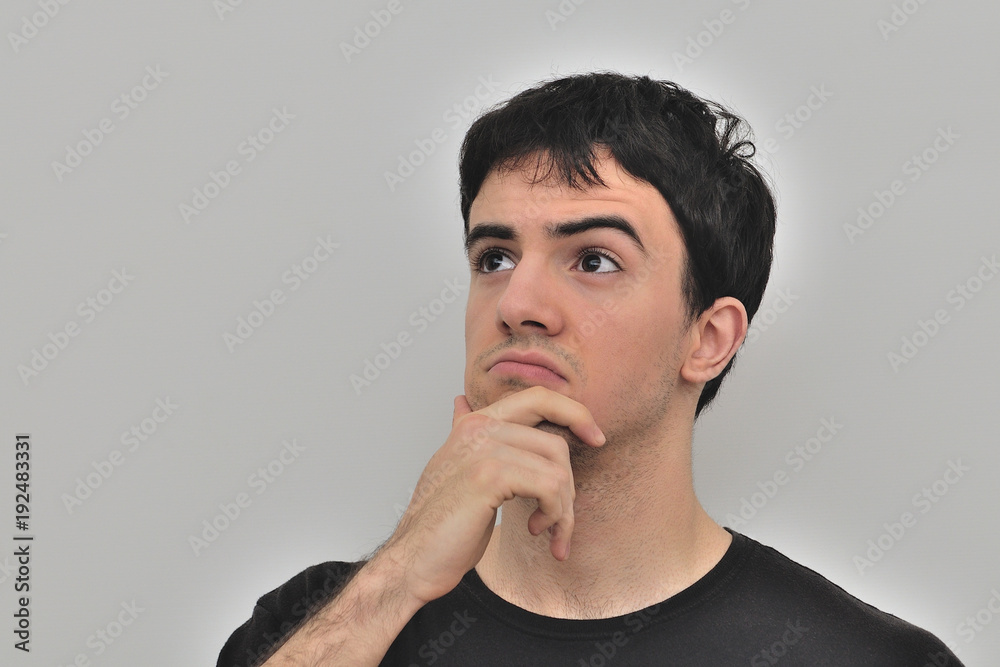 portrait of a pensive young man on a white background portrait of a pensive young man on a white background