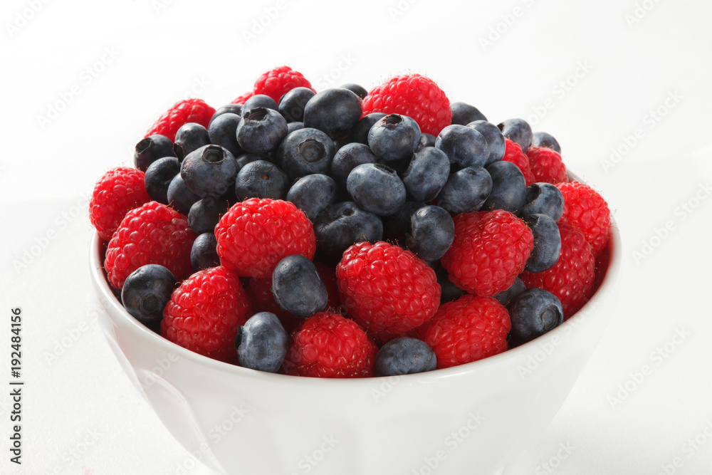Close up of blueberries and raspberries on White Background Close up of blueberries and raspberries on White Background