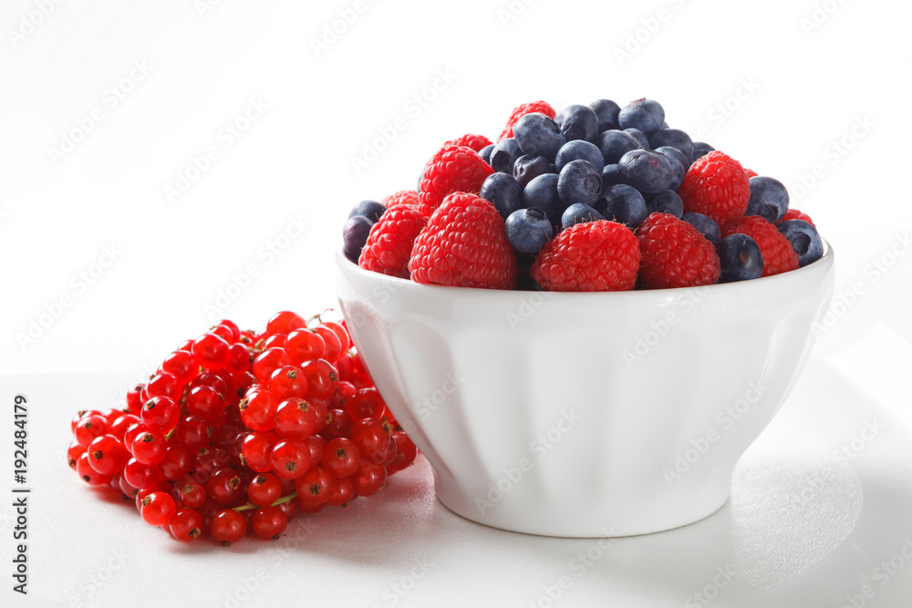 Fresh Berries in White Bowl on White Background Fresh Berries in White Bowl on White Background