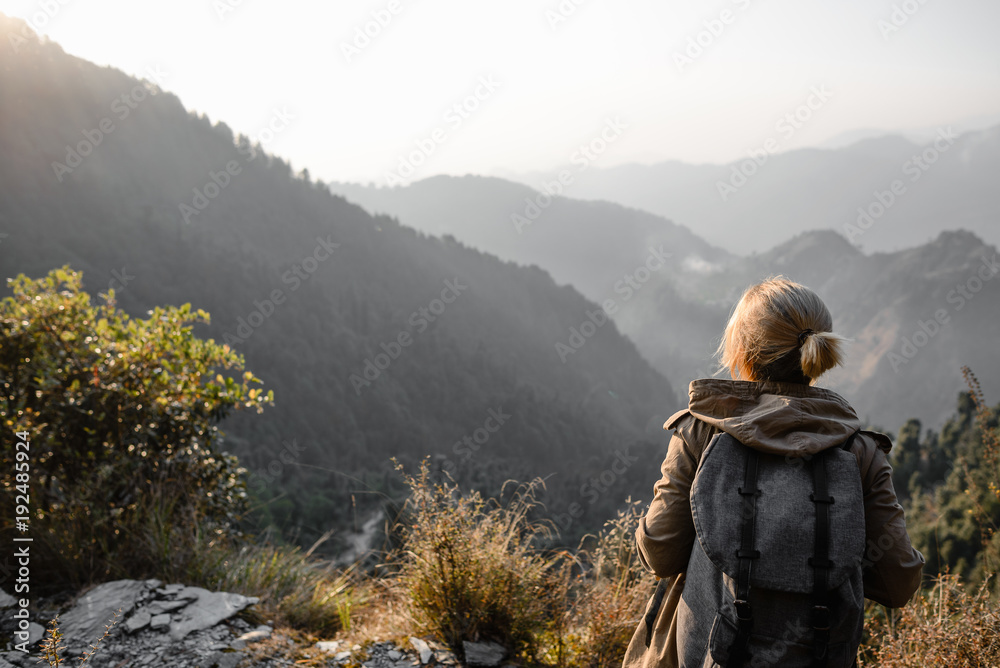 Backpacker girl in the mountains