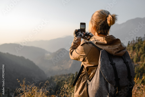 Backpacker  girl make photo by phone