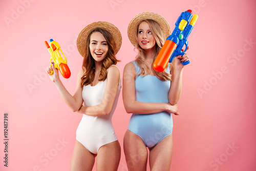 Portrait of a two cheerful girls dressed in swimsuits photo