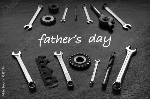 Fathers Day message with tool set. Black textured background.