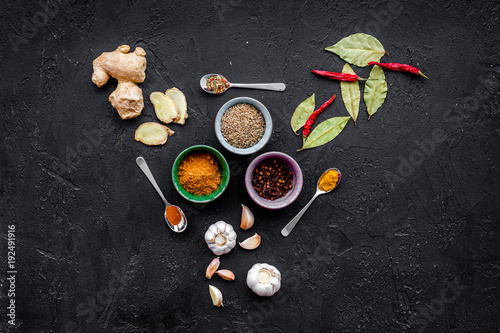 Gastronomy, culinary. Secrets of tasty dishes. Seasoning and spices on black background top view copy space