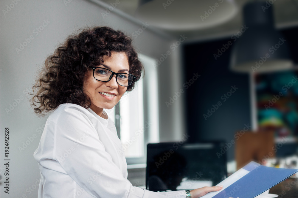Portrait of business woman in office. Portrait of business woman in office.