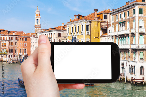 tourist photograps palaces on Canal in Venice photo