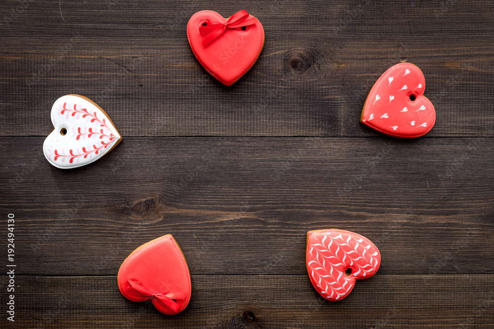 Fototapeta premium St Valentine's Day cookies in shape of heart on dark wooden background top view copy space
