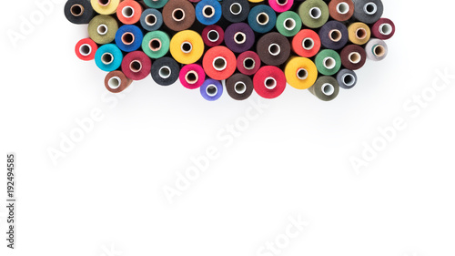 Set of coloured thread coils on white background, sewing supplies, text ready, banner, book or magazine cover, textile background