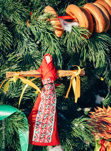 Rag Dolls on christmas tree on folk Slavic pagan holiday Maslenitsa of the end of winter. photo