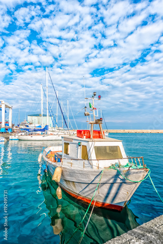 Boat moored at Monopoli port - Italy, Puglia. Adriatic sea