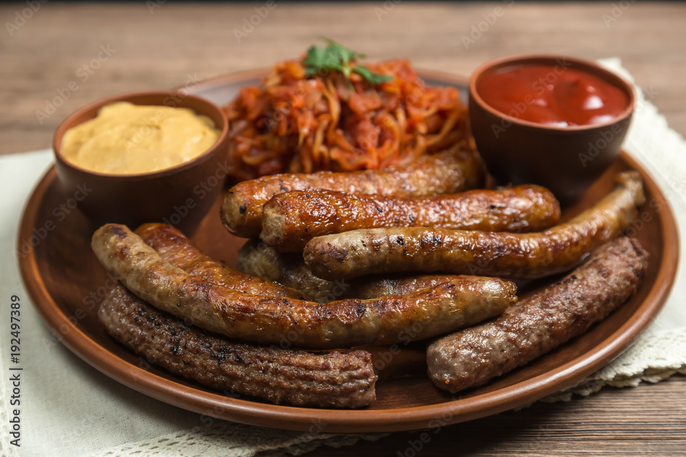 Assorted fried sausages and stewed cabbage. 