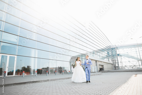 Perfect couple bride, groom posing and kissing in their wedding day