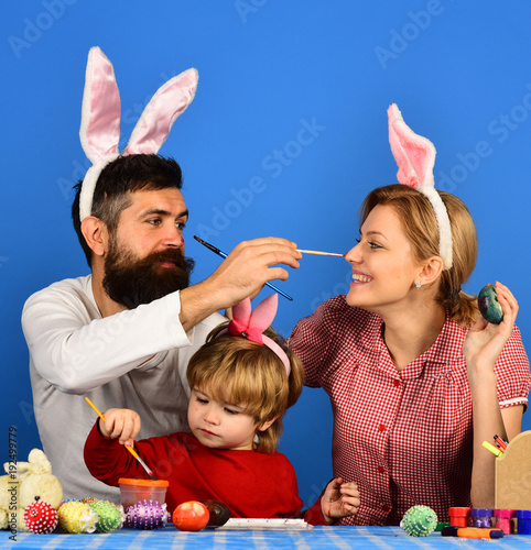 Man, woman and kid wearing bunny ears
