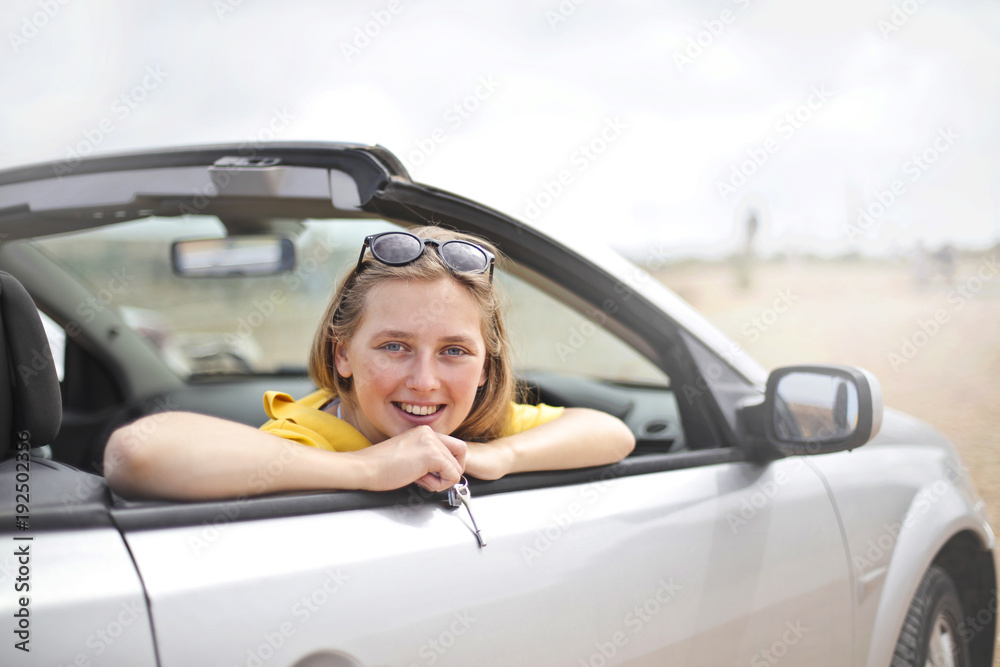 Smiling woman in a sporty car