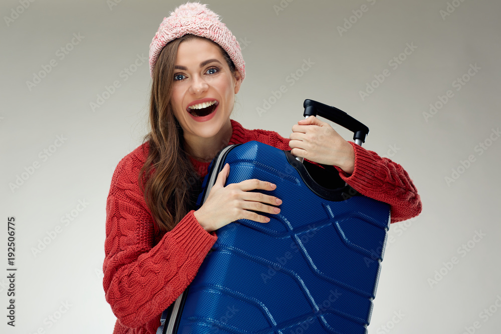 Portrait of smiling woman in red hugging with suit case. Portrait of smiling woman in red hugging with suit case.