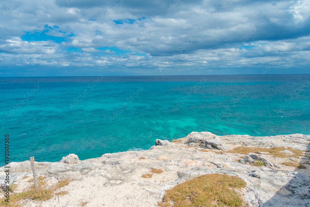 Beautiful outdoor view on the edge of the cliff Isla Mujeres Punta sun caribbean sea, with a turquoise water and gorgeous sunny day in Mexico Beautiful outdoor view on the edge of the cliff Isla Mujeres Punta sun caribbean sea, with a turquoise water and gorgeous sunny day in Mexico