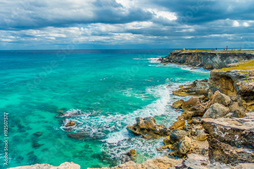 Beautiful view of rocky cliff and turquoise water at sunrise on the the southern part of the Isla Mujeres in Caribbean, Mexico photo