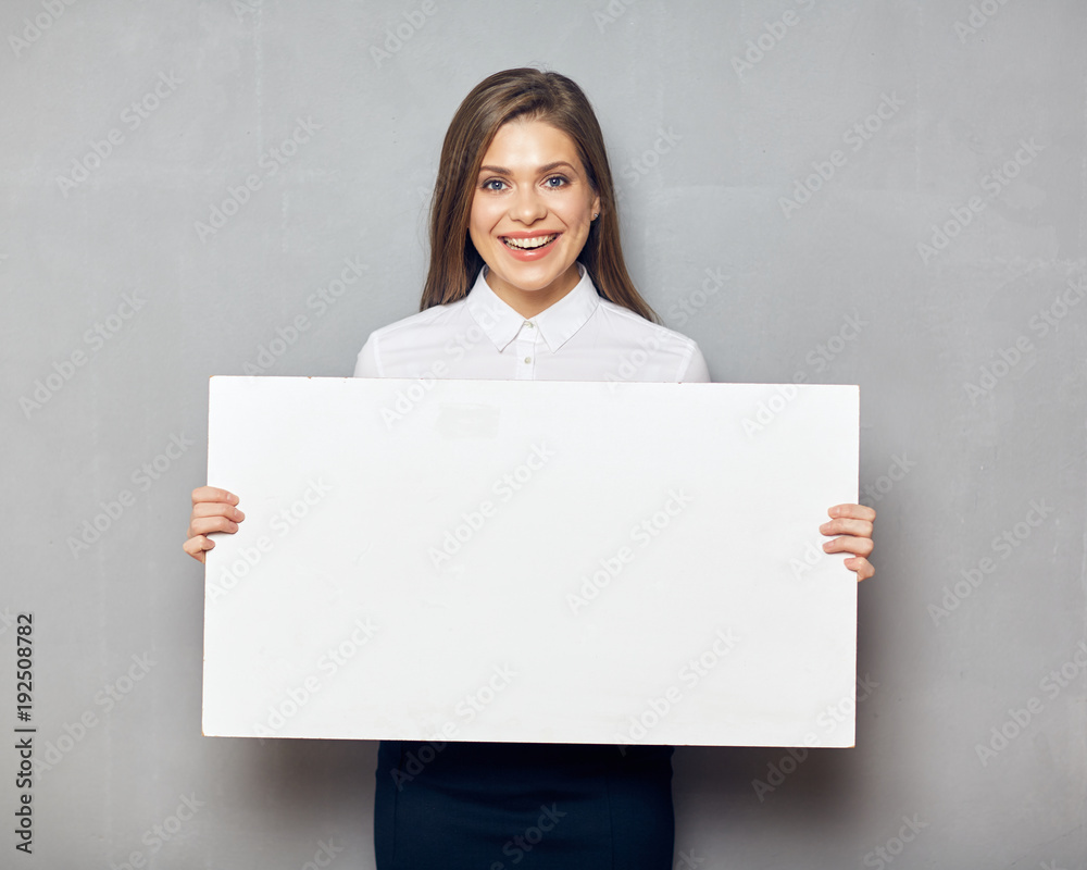 Young business woman smiling with teeth holding blank white boar Young business woman smiling with teeth holding blank white boar