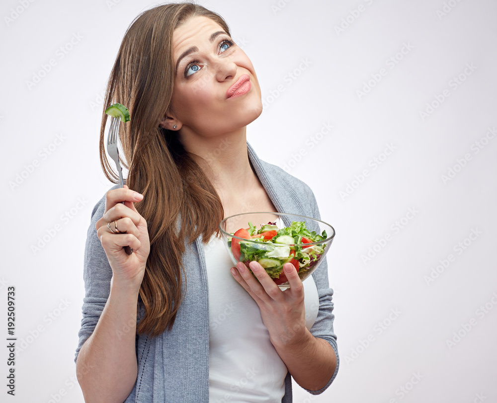 Thinking woman holding sald bowl with fork. Thinking woman holding sald bowl with fork.