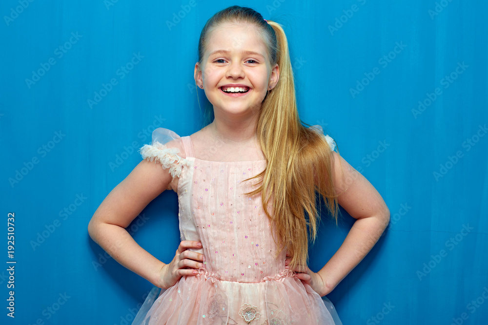 Happy little girl with long blond hair wearing pink dress. Happy little girl with long blond hair wearing pink dress.