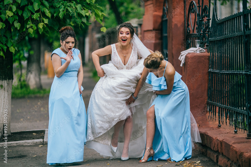 beautiful bride and her bridesmaids walking together. Funny moments on  wedding day with best friends. Young woman with flowers. Stock Photo |  Adobe Stock
