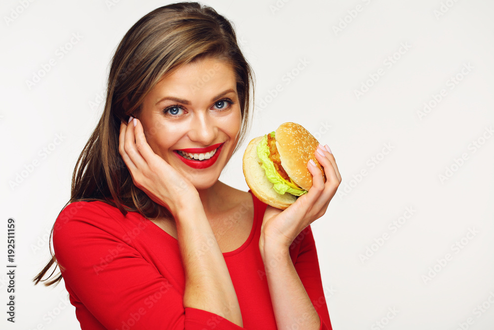 Woman holding big burger embarrassed. Woman holding big burger embarrassed.