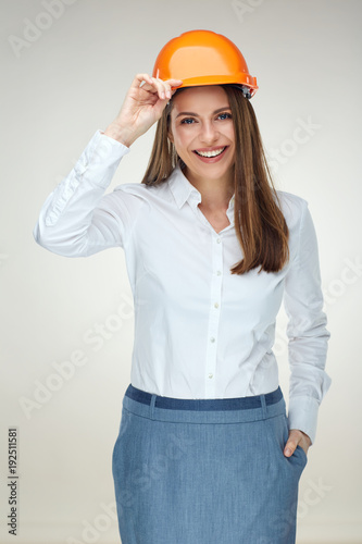 Smiling woman engineer builder worker touching her protect helme