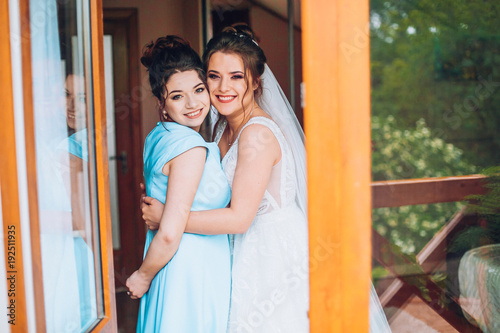 Portrait of bride with bridesmaid in hotel hall. © nataliakabliuk