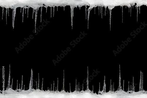 Icicles on a black background, space for text, template for design photo