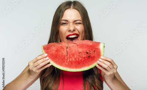 Fun portrait of young woman with big piece of watermelon