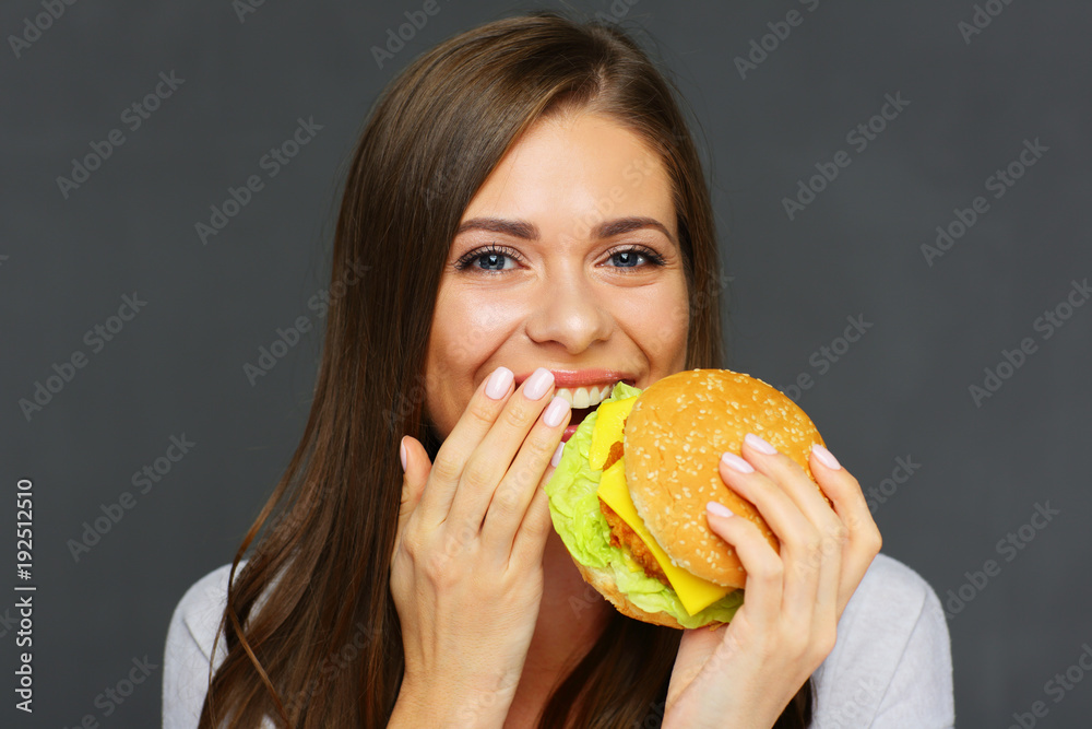 Close up portrait of woman eating burger Close up portrait of woman eating burger