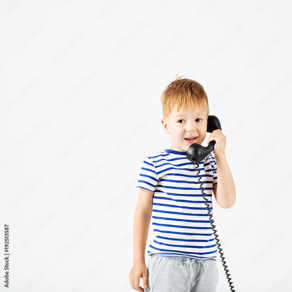 little boy with retro phone against a white little boy with retro phone against a white