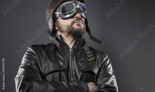 old airplane pilot with brown leather jacket, arador hat and large glasses