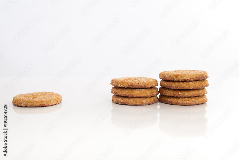 piles of round cookies on studio white background piles of round cookies on studio white background
