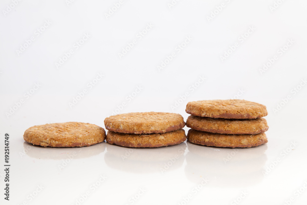 piles of round cookies on studio white background piles of round cookies on studio white background