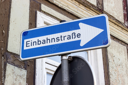 one-way street / Road sign with german text: one-way street in front of a half-timbered house 