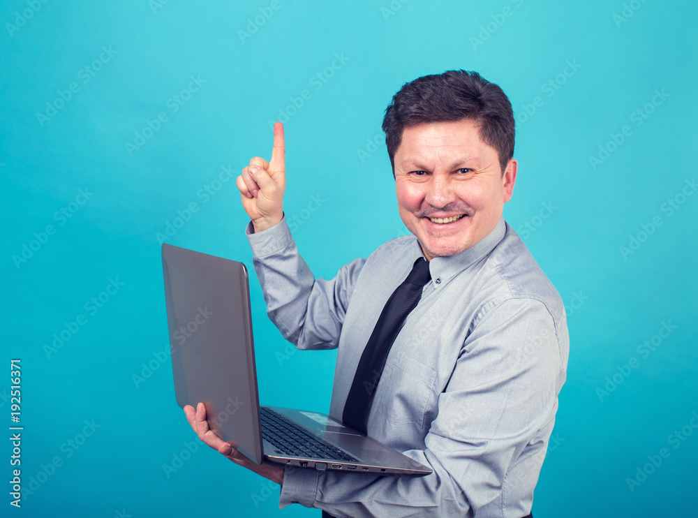 Adult man is holding a laptop computer. Man showing his finger up.