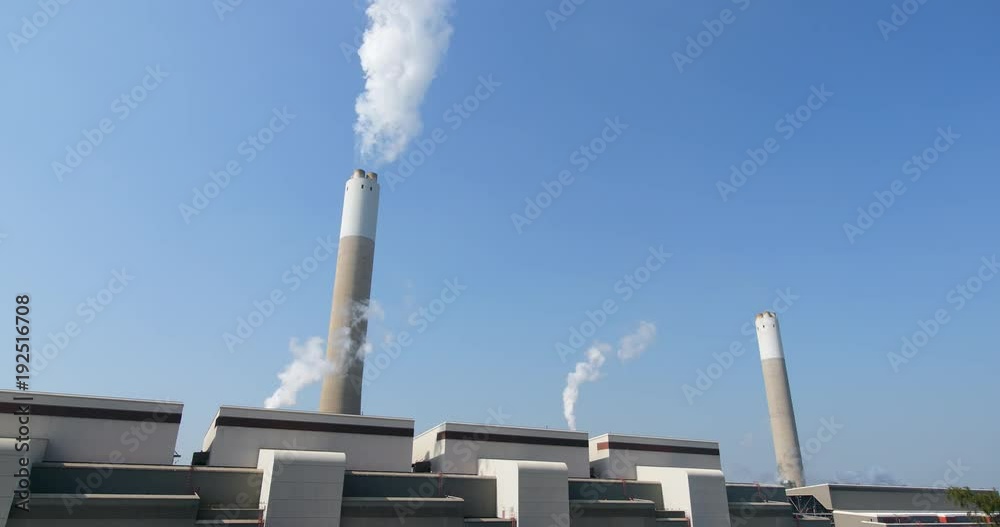 Factory with Smoke stack over blue sky Factory with Smoke stack over blue sky