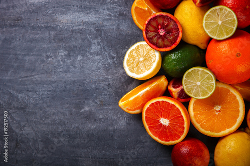 Different Citrus Fruit on a Grey Background .Mixed Colorful Tropical Background.Food or Healthy diet concept.Vegetarian.Copy space for Text. selective focus. © lily_rocha
